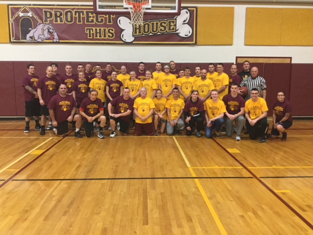 Alumni basketball players pose after the Alumni Association Basketball game.
