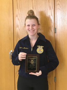 Kayleigh Reynolds-Flynn poses with her plaque from her sub-state FFA win