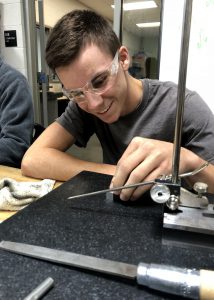 boy in safety goggles working on machine