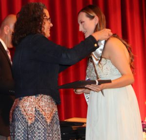 girl presented her award certificate