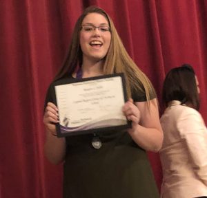 girl hold her award certificate