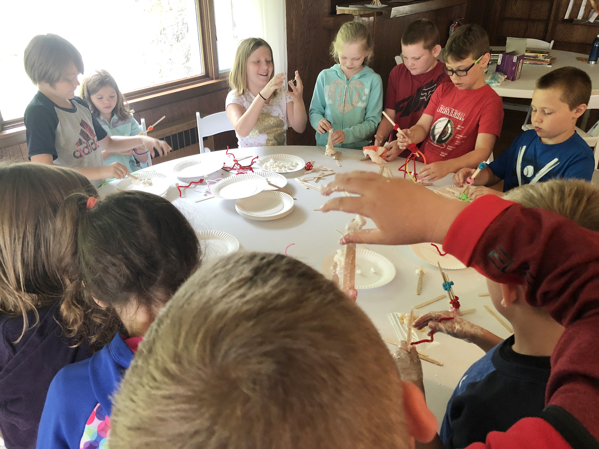 group of student work at a table on a project together