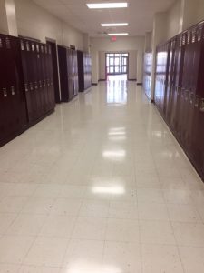 school hallway with lockers and shiny floor