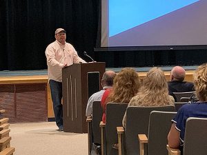 Nathan Elble speaks in auditorium