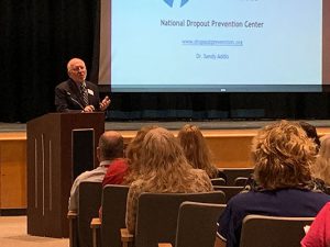 Sandy Addis speaks in auditorium