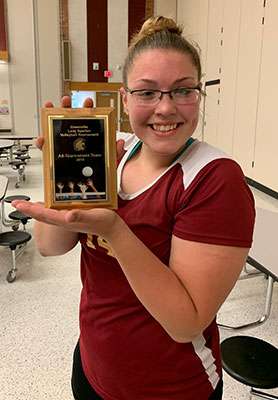 Reagan Smith holding award plaque