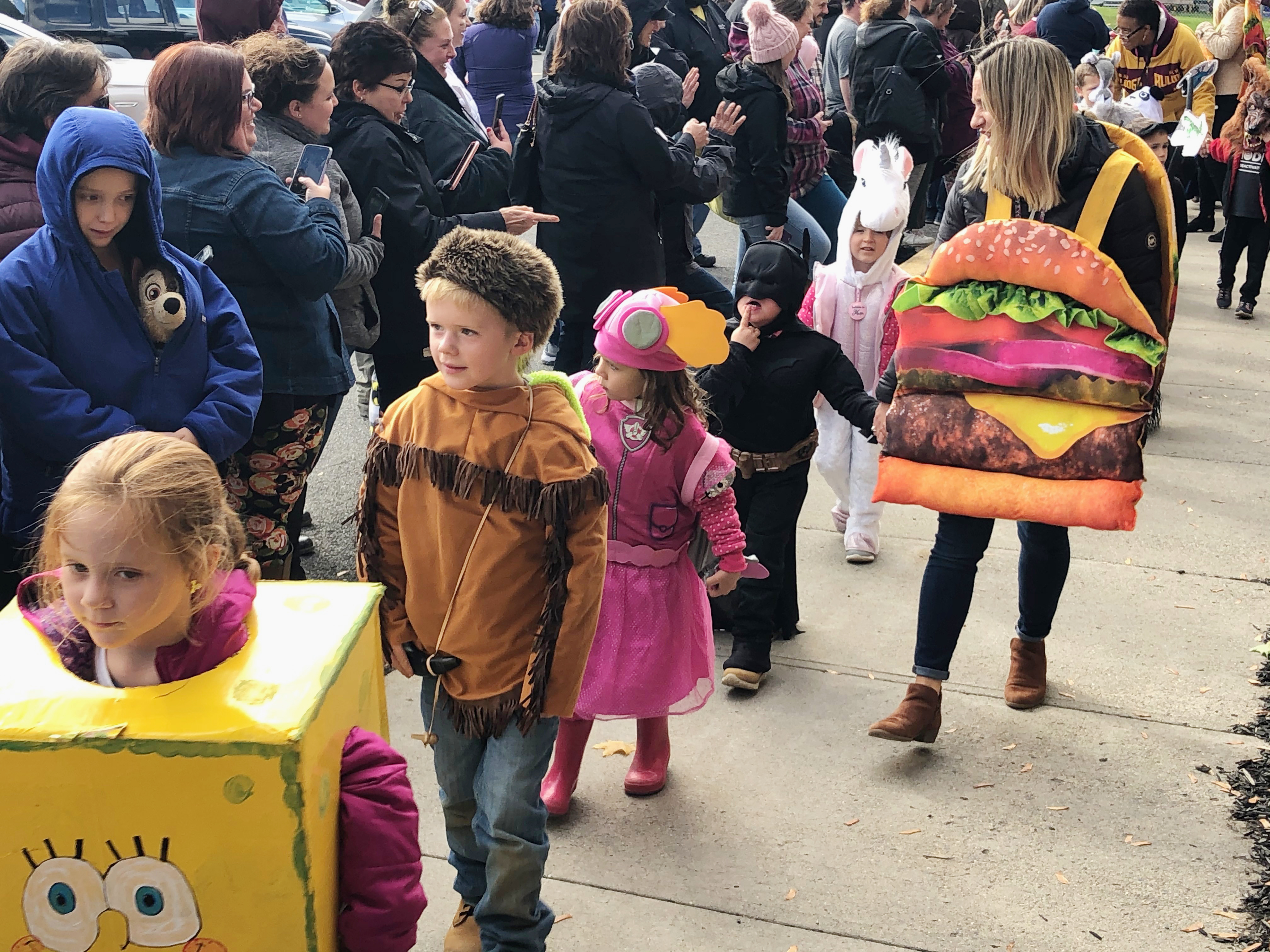 children march in halloween costumes