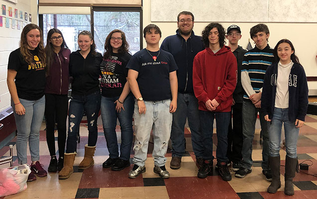 group of high school students standing together after helping at the event