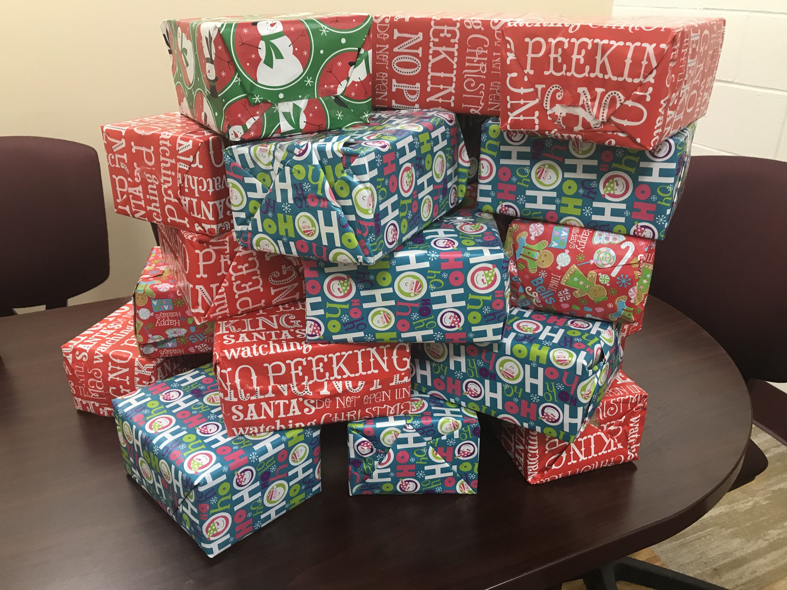 stack of wrapped Christmas gifts