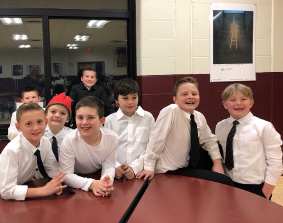 group of elementary kids dressed in white shirts