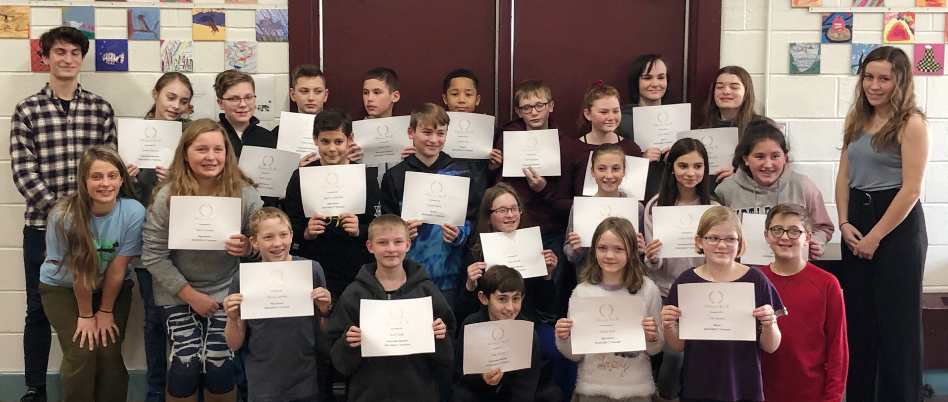 large group of students holding their award certificates