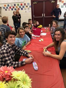 students sit at a long table