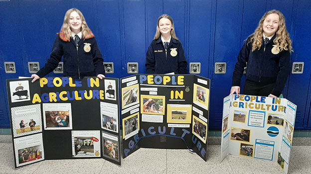 FFA students standing behind their displays