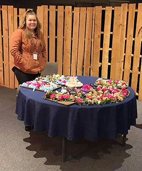 Graycie Swain at the event behind table of boutonnieres