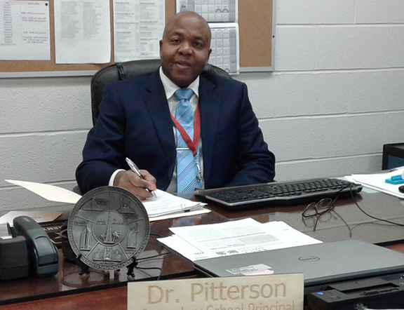 Dr. Mark A. Pitterson, seated at desk
