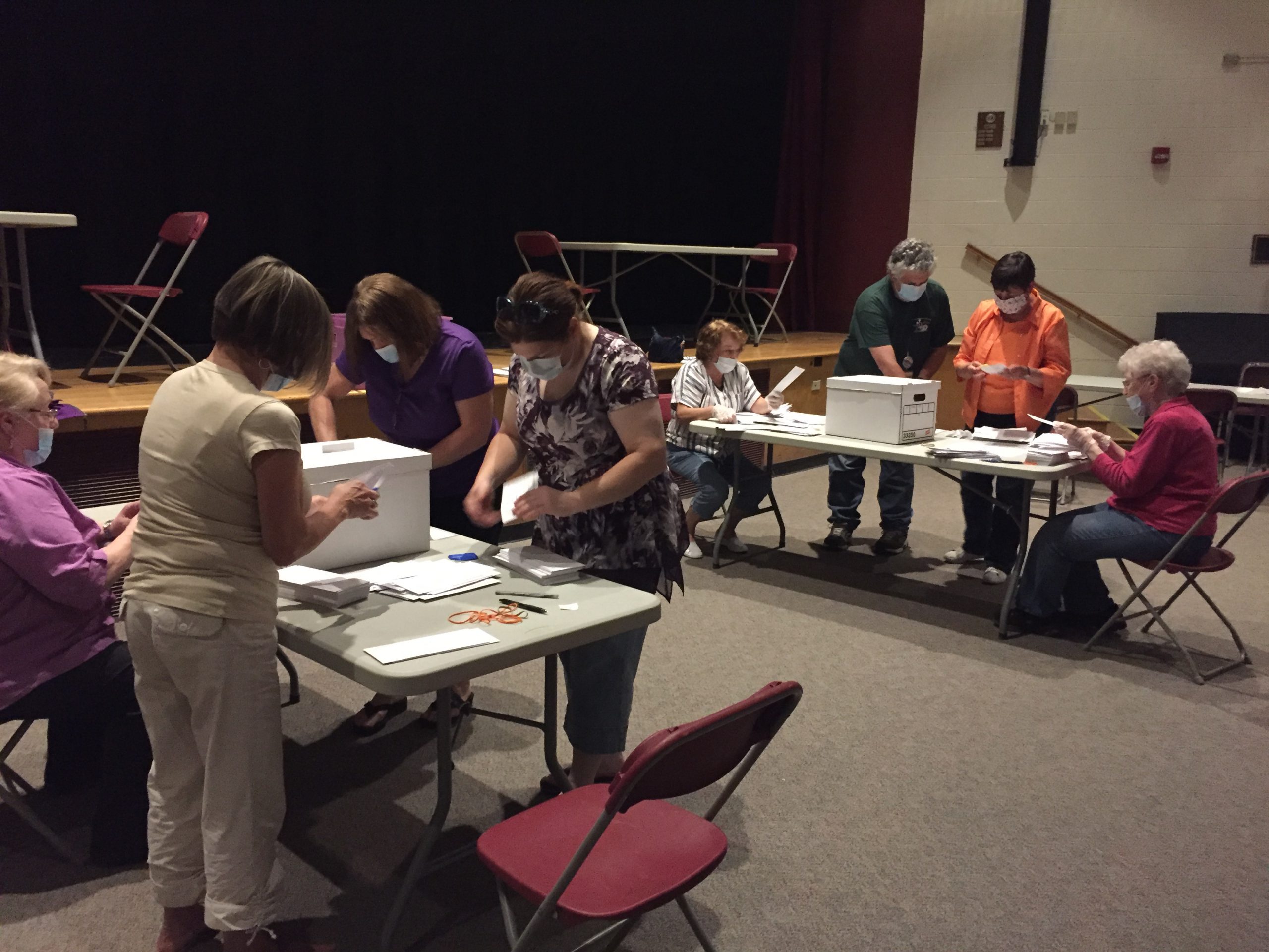 people count election ballots at tables