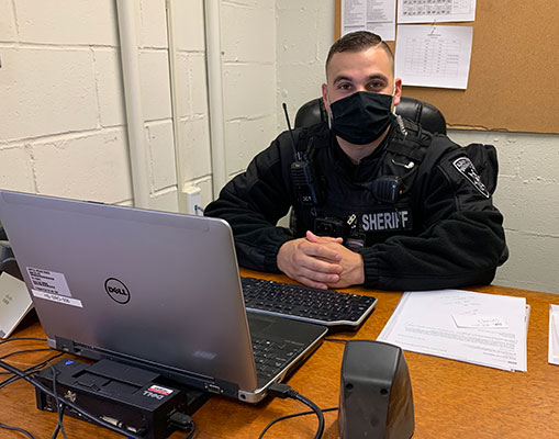 Deputy Stone sitting at his desk