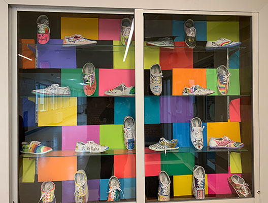 Display case filled with anti-bullying messaged shoes