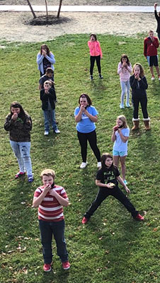 5th graders eating apples in front of BKW Elementary School