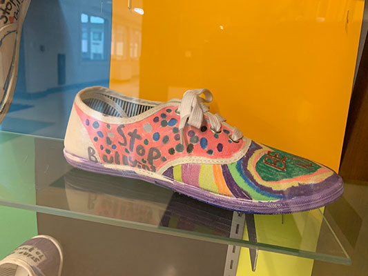 shoe decorated with stop bullying  and be kind messages