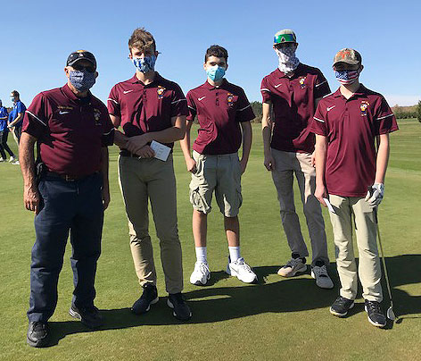 Coach and golf team pose as a group