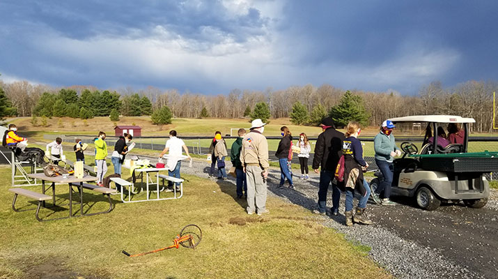 Kiwanis and students at the track next to the trail