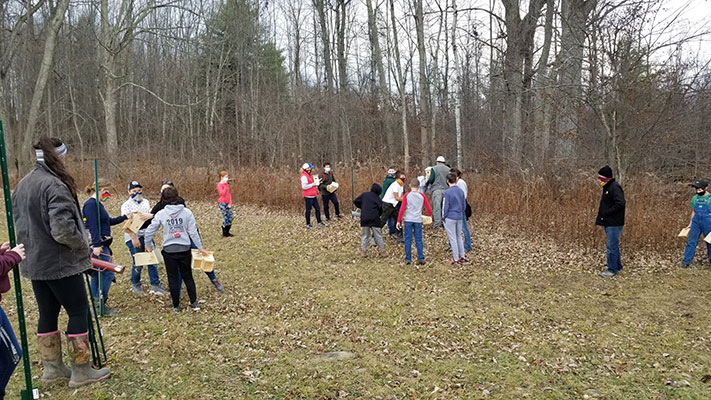 Kiwanis and students working on trail 