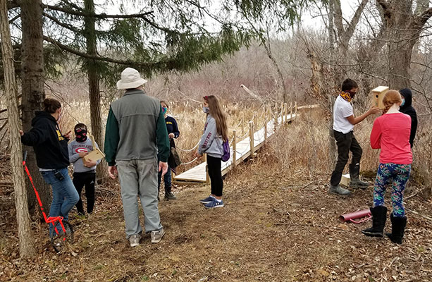 Kiwanis and students working on the trail