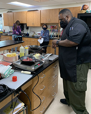 Lateef Clark cooking in classroom