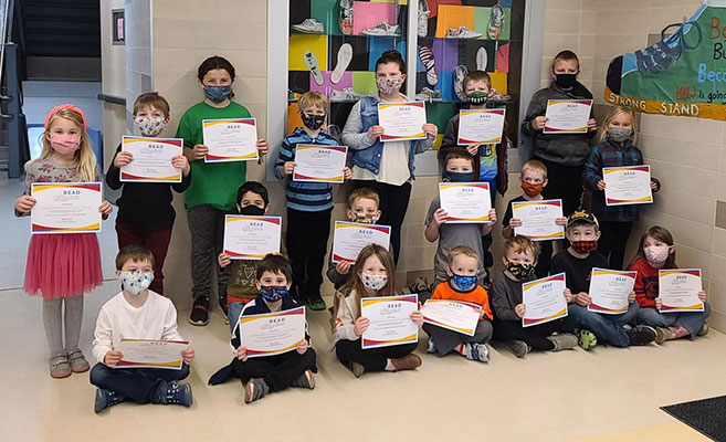 group of students holding certificates