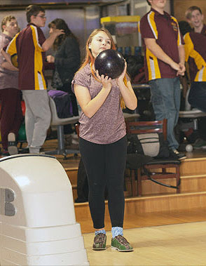 girl holding bowling ball