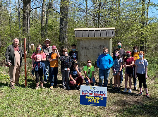 students standing by U'hai Trailhead sign