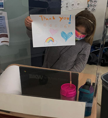 student holding Thank you sign