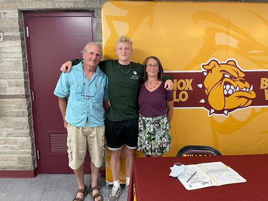 Zeke with family at signing