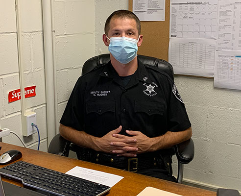 Deputy Hughes sitting at a desk