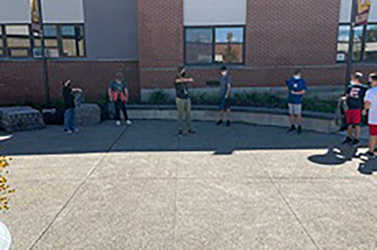 students standing outside school building