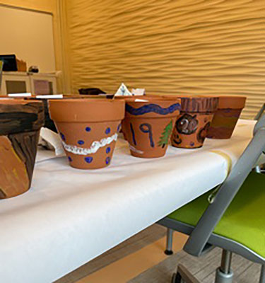 painted pots on a shelf