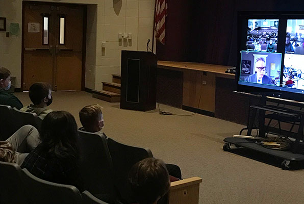Jack Gantos and images on video screen in front of seated students