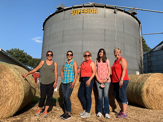 teachers standing in front of silo