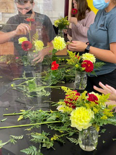 students working on floral arrangements