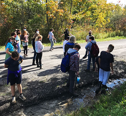 students in a group outside on a path