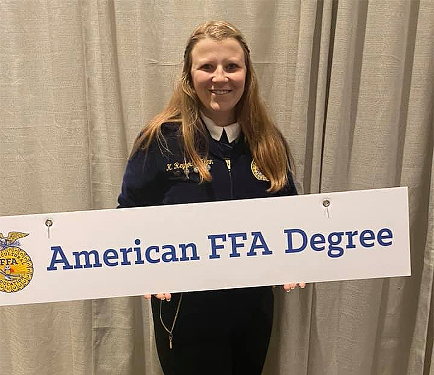 Kayleigh Reynolds-Flynn holding American FFA Degree sign