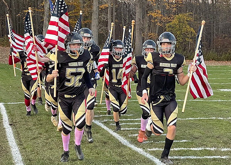 football players holding flags