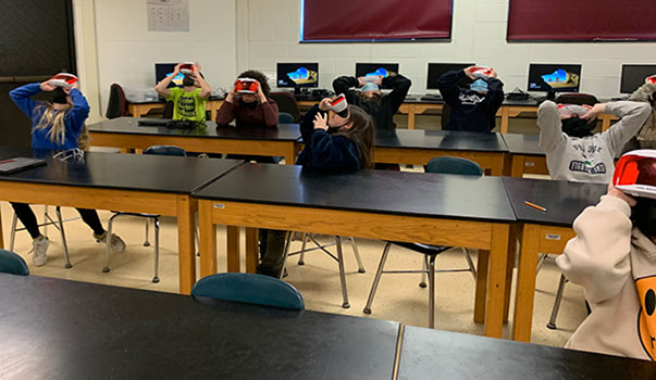 students looking through VR goggles