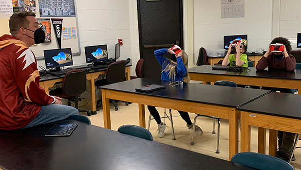 teacher talking to students looking through VR googles