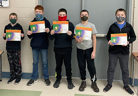 students standing holding certificates