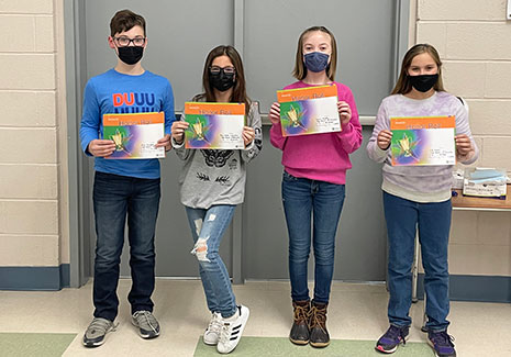 students standing holding certificates