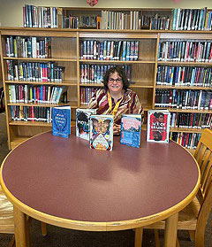 Beth Davis seated at a table in the library