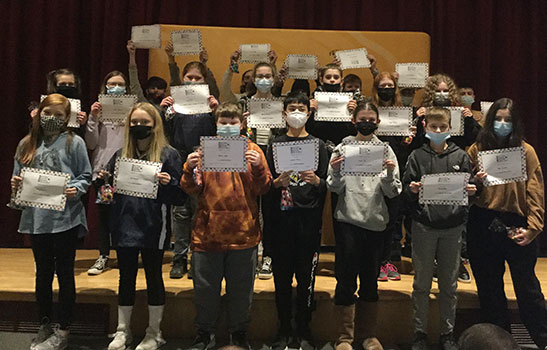 students in a group holding certificates