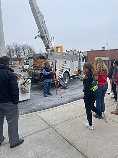 students watch National Grid demo outside their school